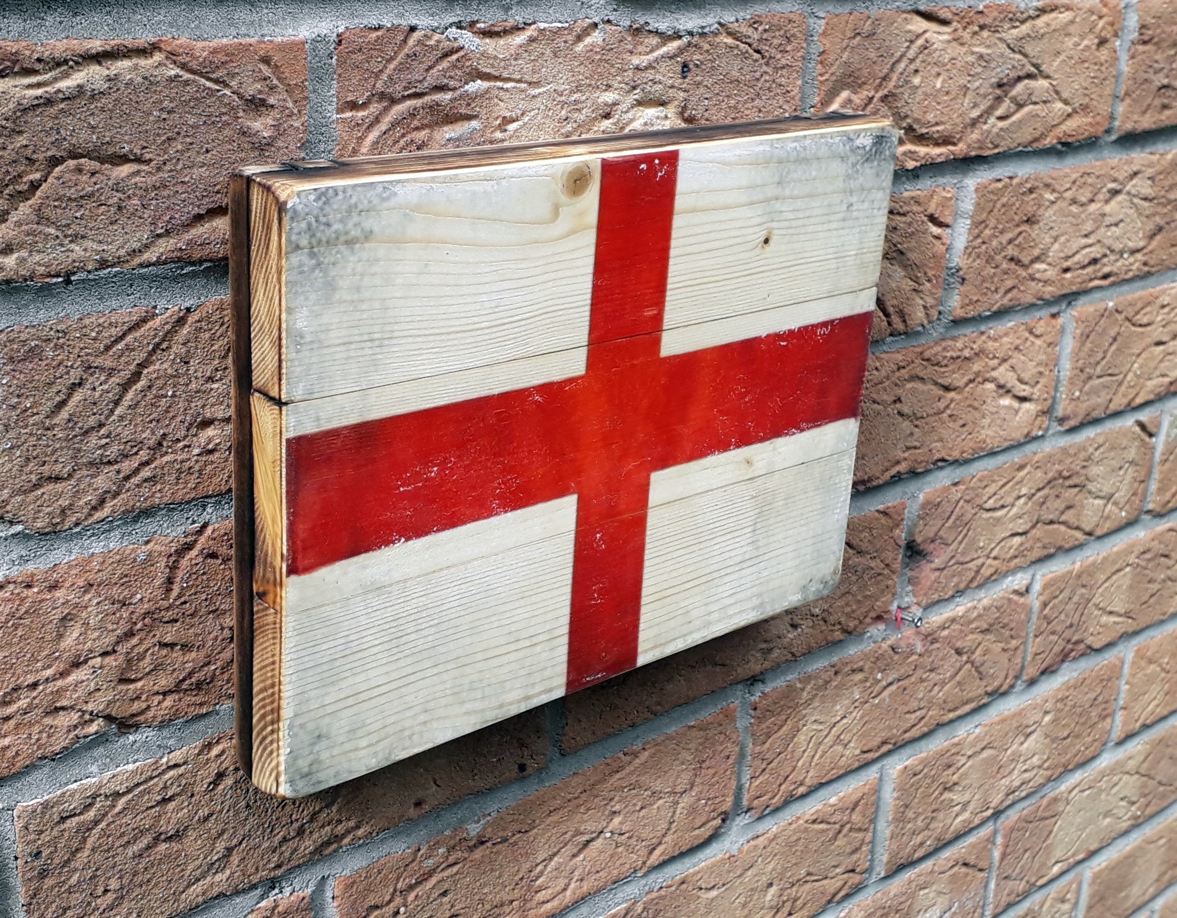 England flag on the rustic wood with burnt edges