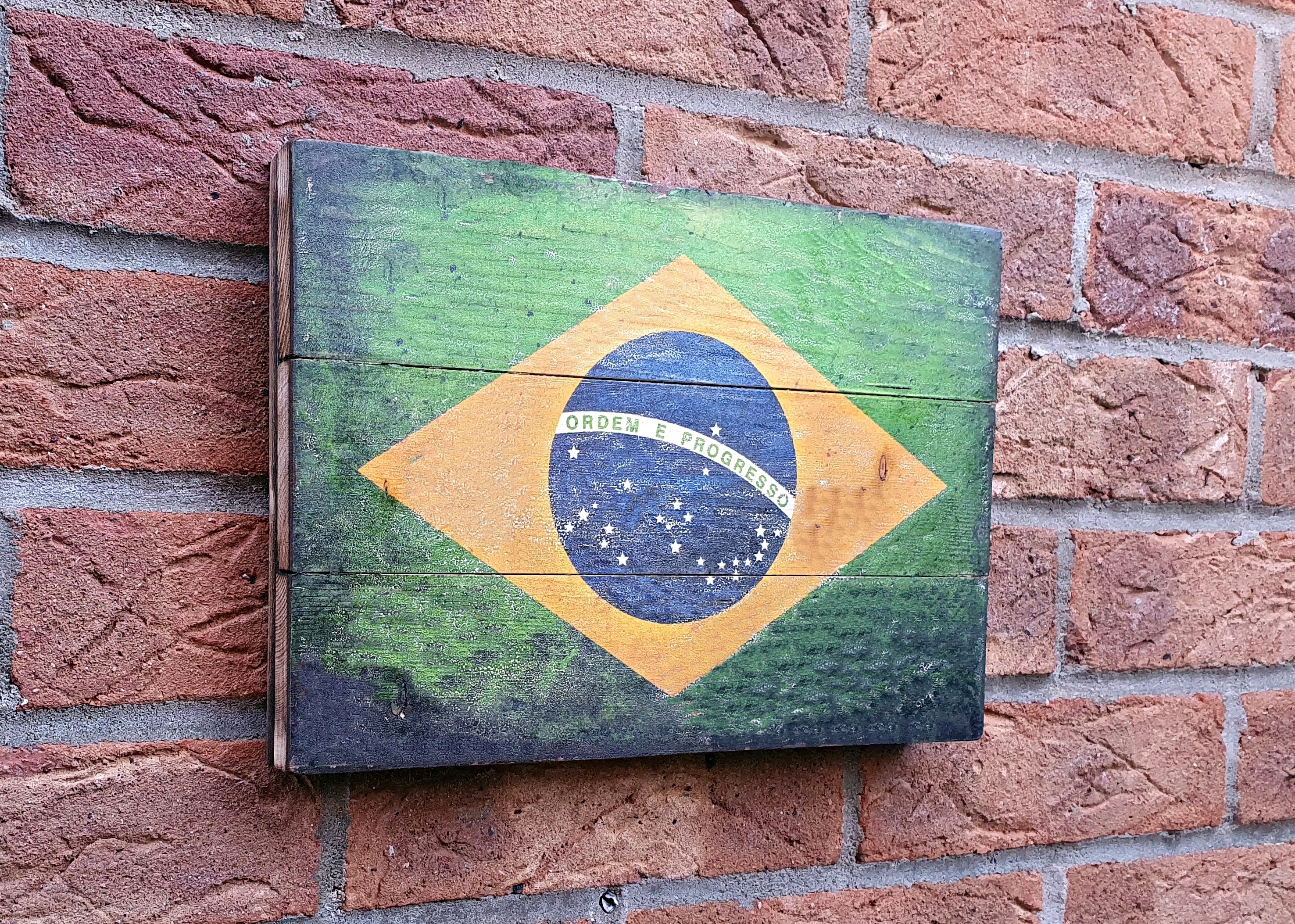 Brazilian flag on the rustic wood with burnt edges