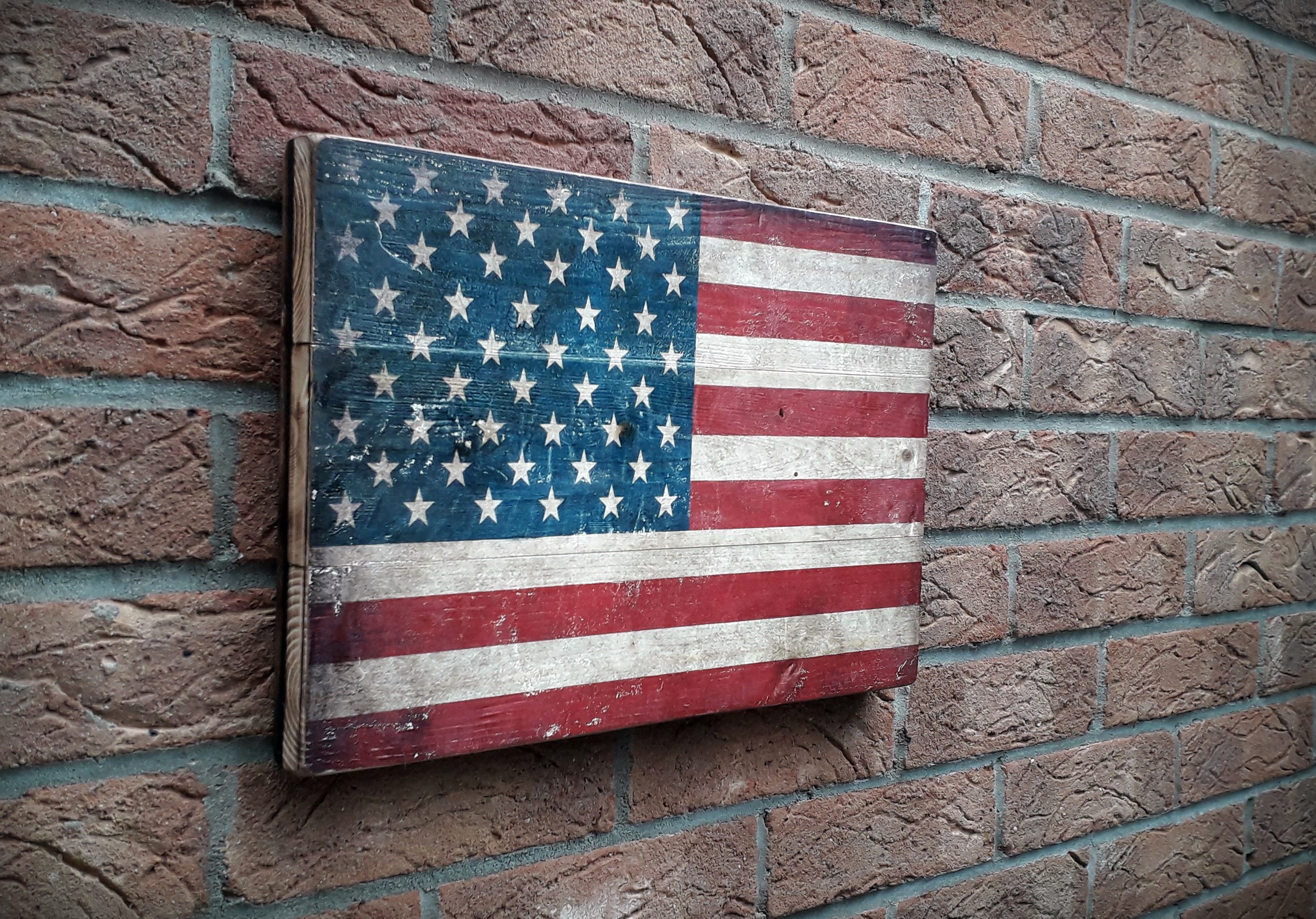 United State flag on the rustic wood with burnt edges