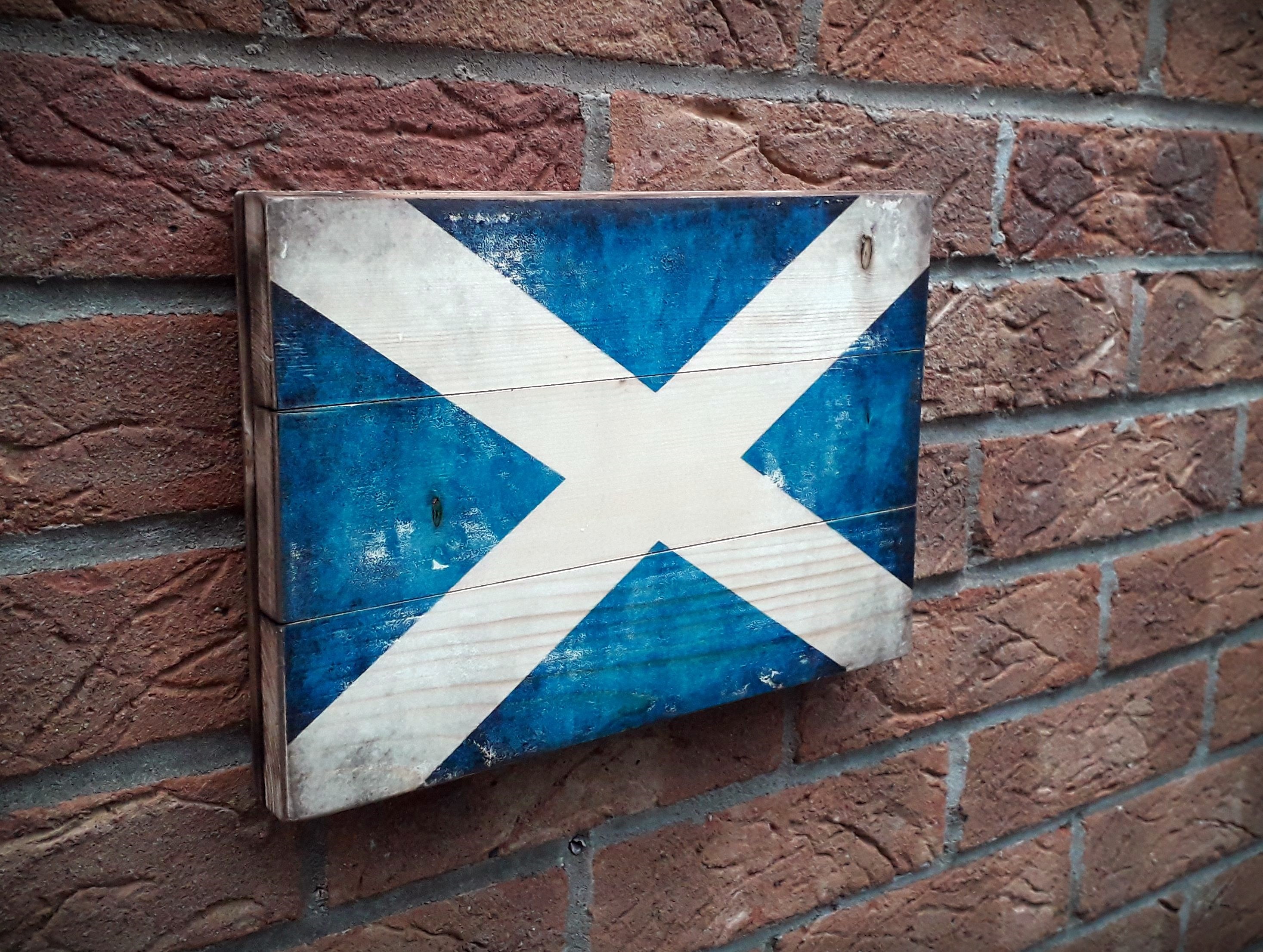 Scotland flag on the rustic wood with burnt edges